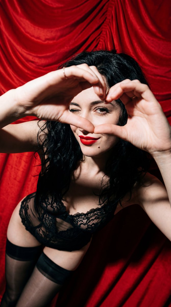 Subject: A young woman with wavy, tousled jet black hair. She...